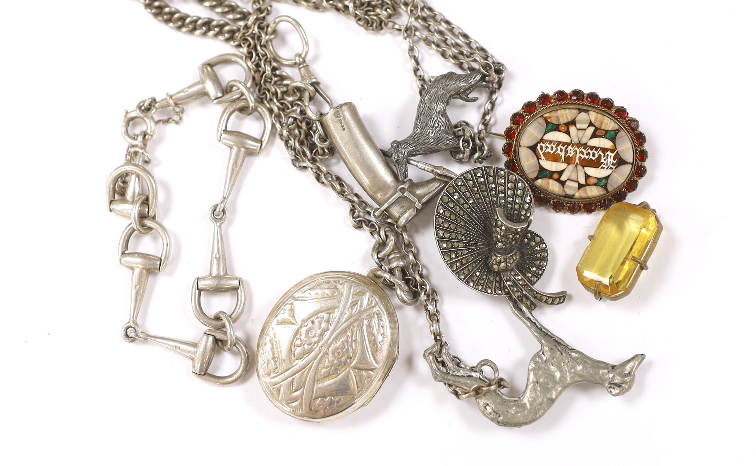 A small group of silver jewellery including a silver albert with riding boot and crop charm, a silver stirrup bracelet, a white metal locket on chain, etc.
